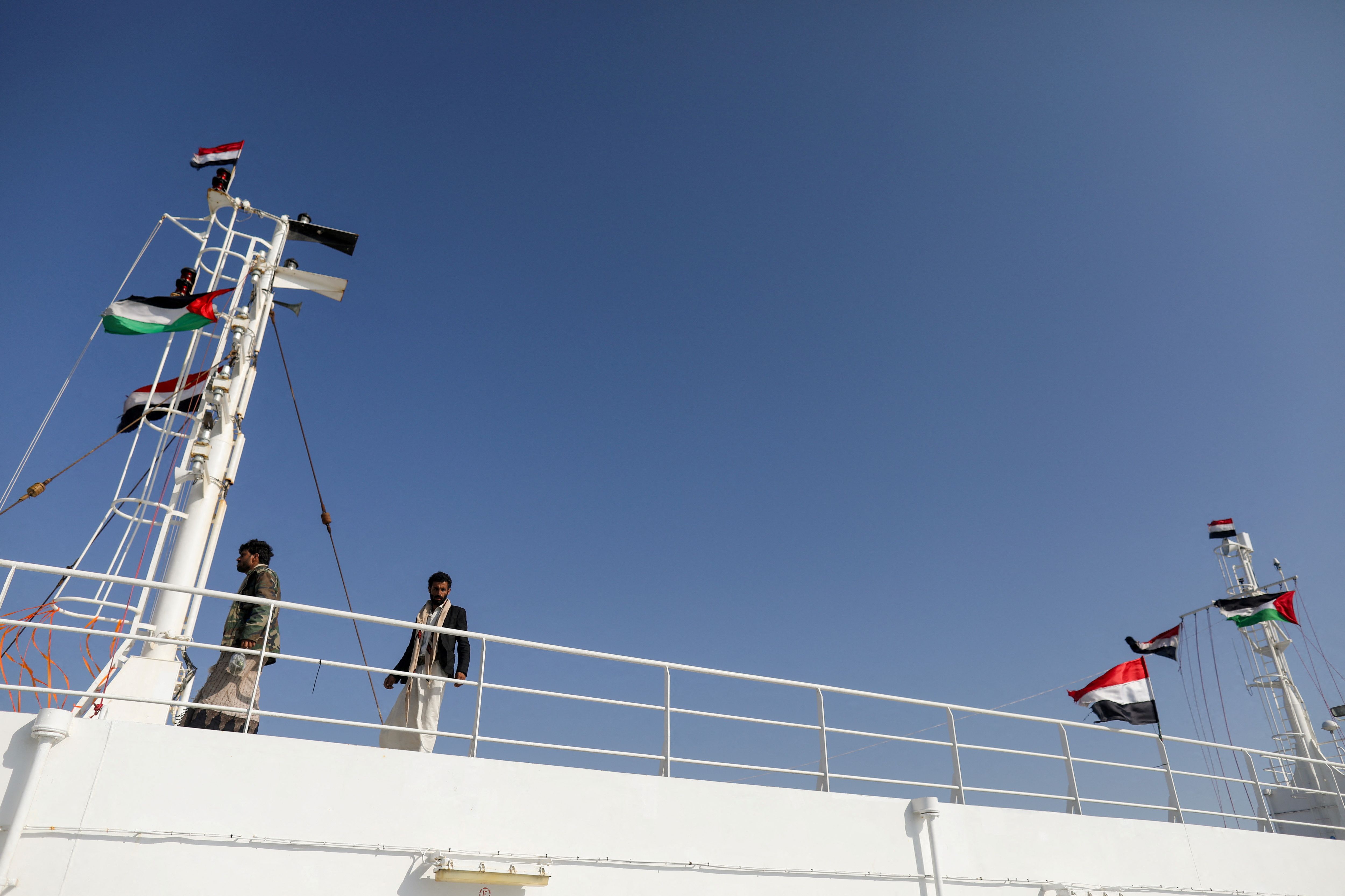 People tour the deck of the Galaxy Leader commercial ship, seized by Yemen's Houthis last month, off the coast of al-Salif, Yemen December 5, 2023. 