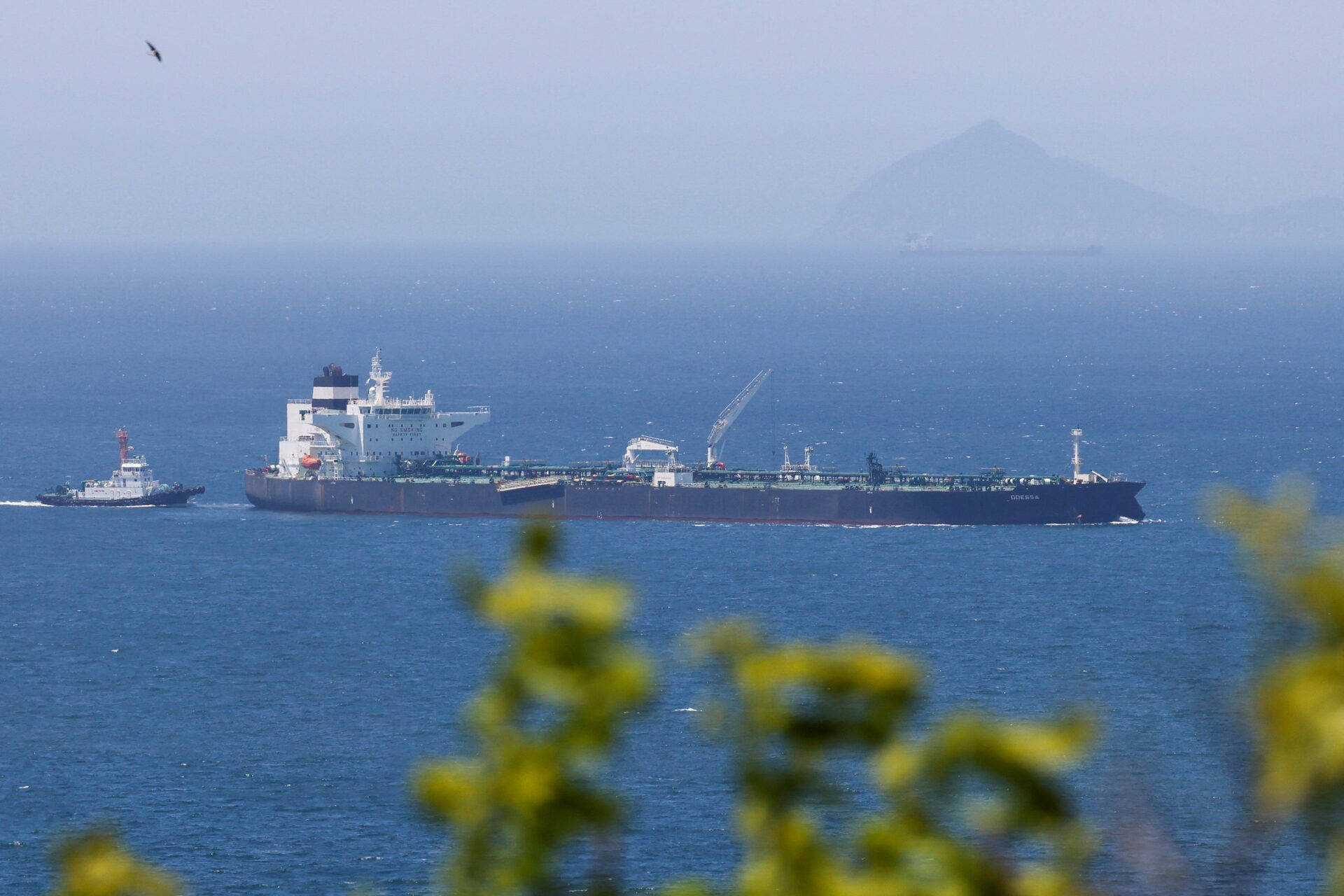 A tugboat guides the crude oil tanker Odessa, carrying UAE crude after passing through the Strait of Hormuz with its Automatic Identification System transponder turned off, navigates the waters at Daesan port, where it is expected to discharge crude oil, in Seosan, South Korea, May 8, 2026. 