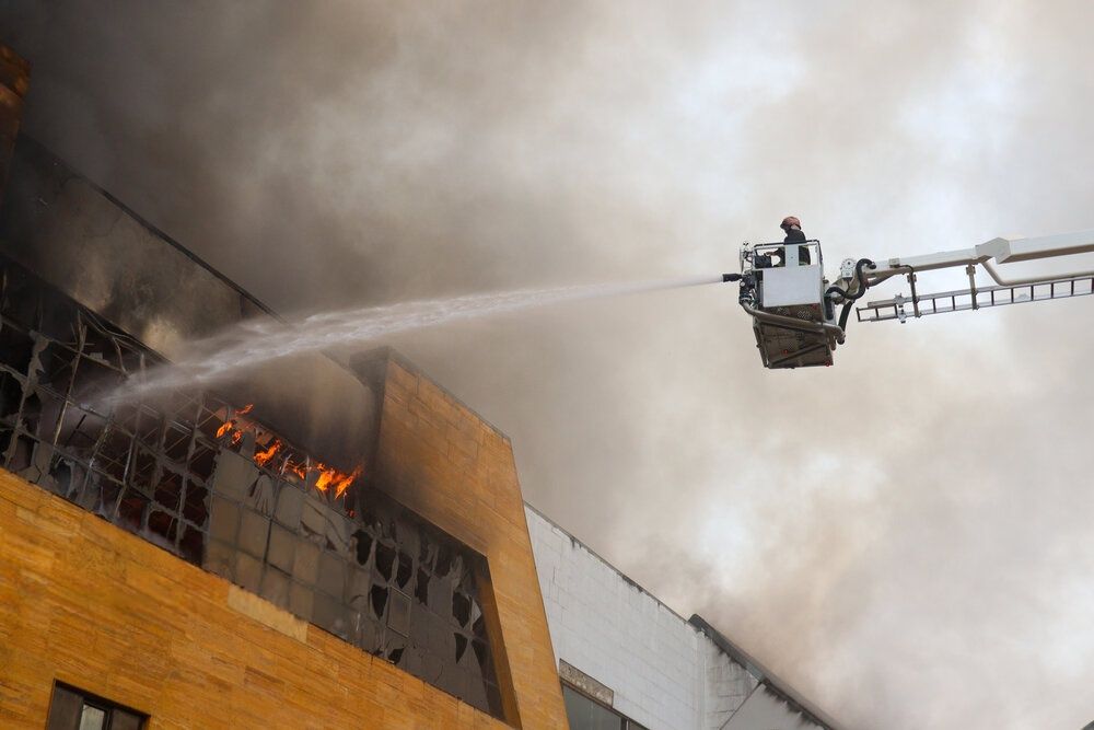 A firefighter sprays water on blazes of a shopping mall in Iran's northern city of Anzali, July 22, 2025