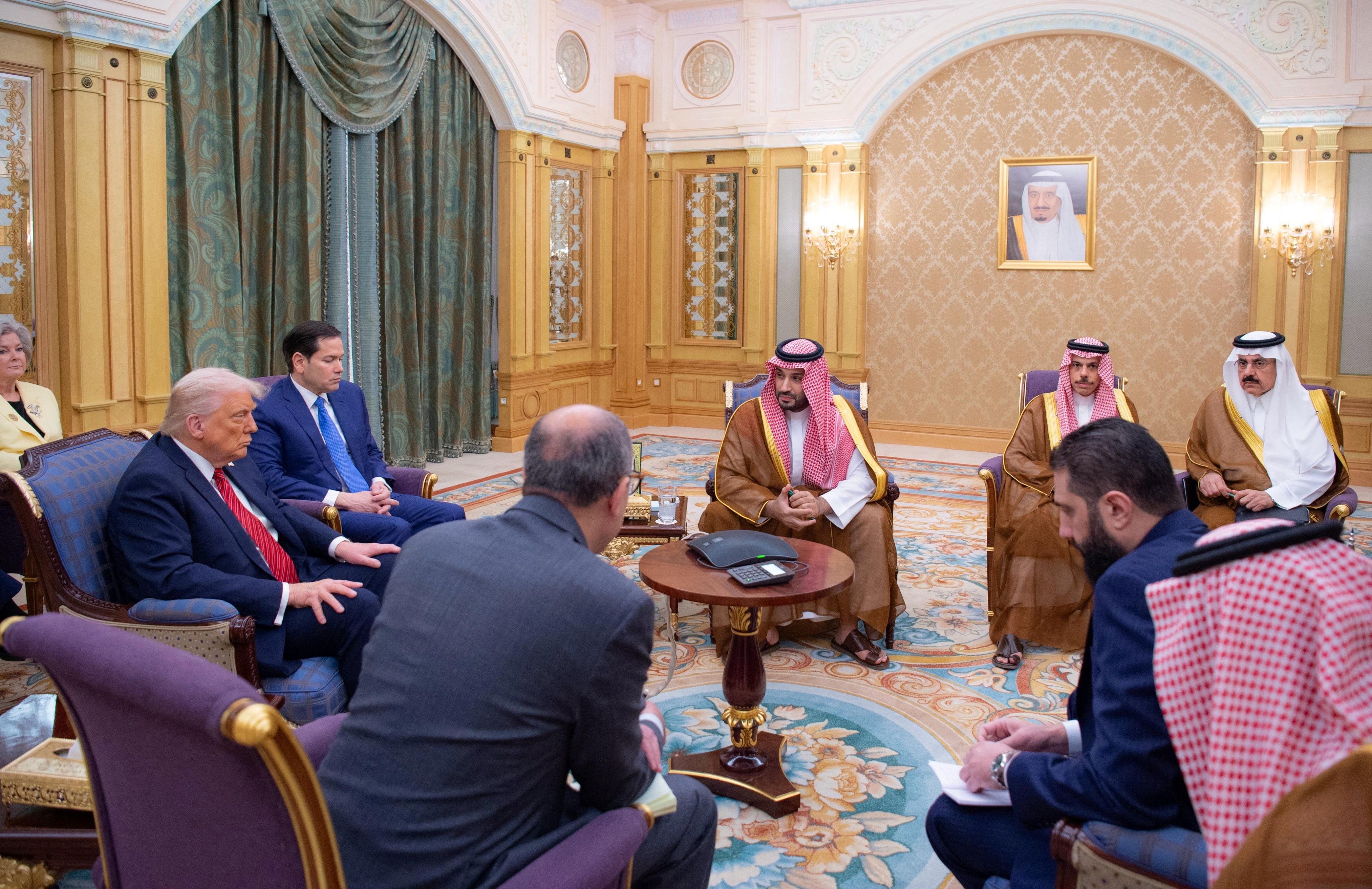Syrian President Ahmed al-Sharaa meets with U.S. President Donald Trump and Saudi Crown Prince Mohammed Bin Salman and other officials in Riyadh, Saudi Arabia, in this handout released on May 14, 2025. 