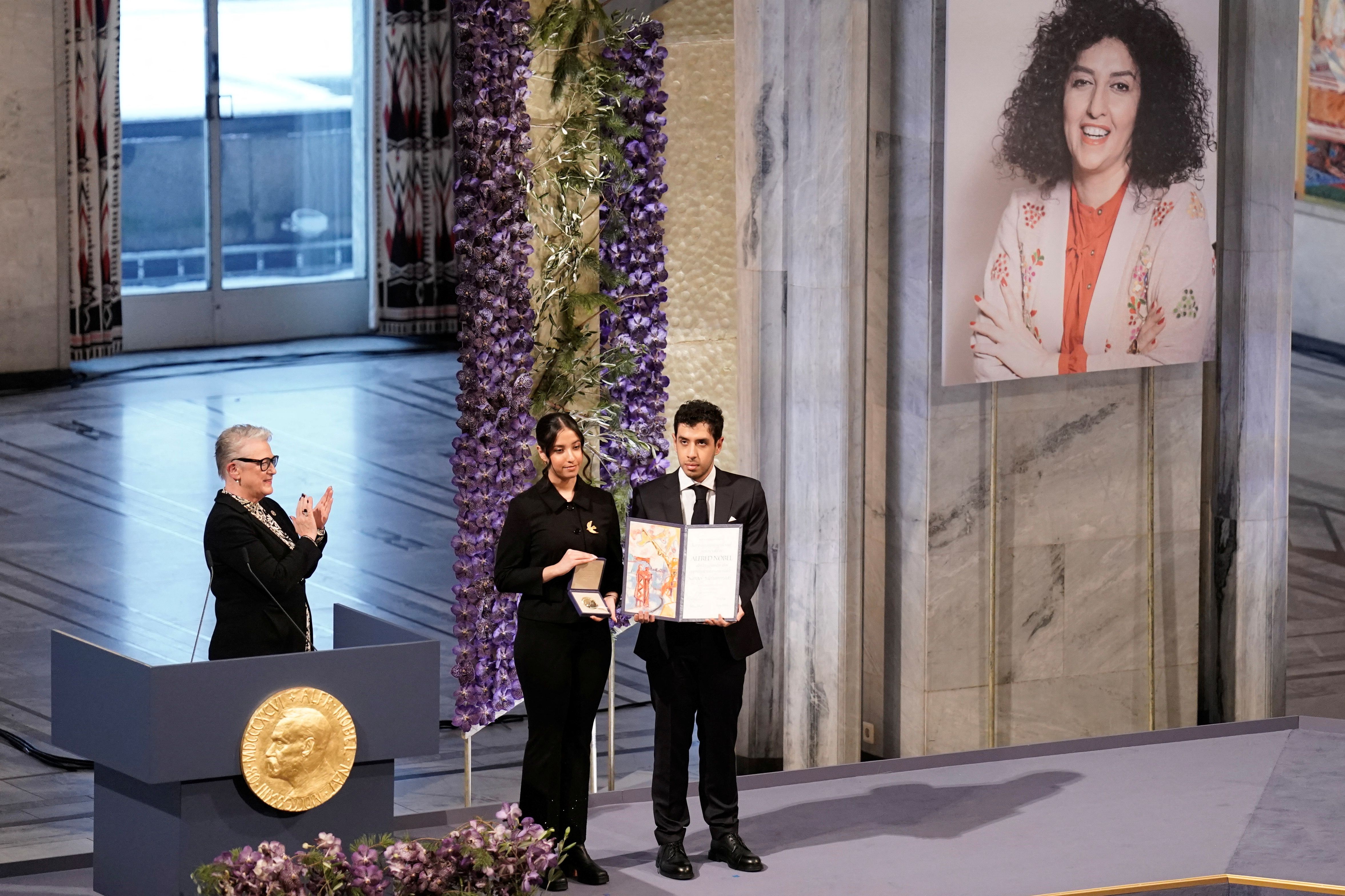 Ali and Kiana Rahmani, children of Narges Mohammadi, an imprisoned Iranian human rights activist, hold the Nobel Peace Prize 2023 award, accepting it on behalf of their mother at Oslo City Hall, Norway December 10, 2023.