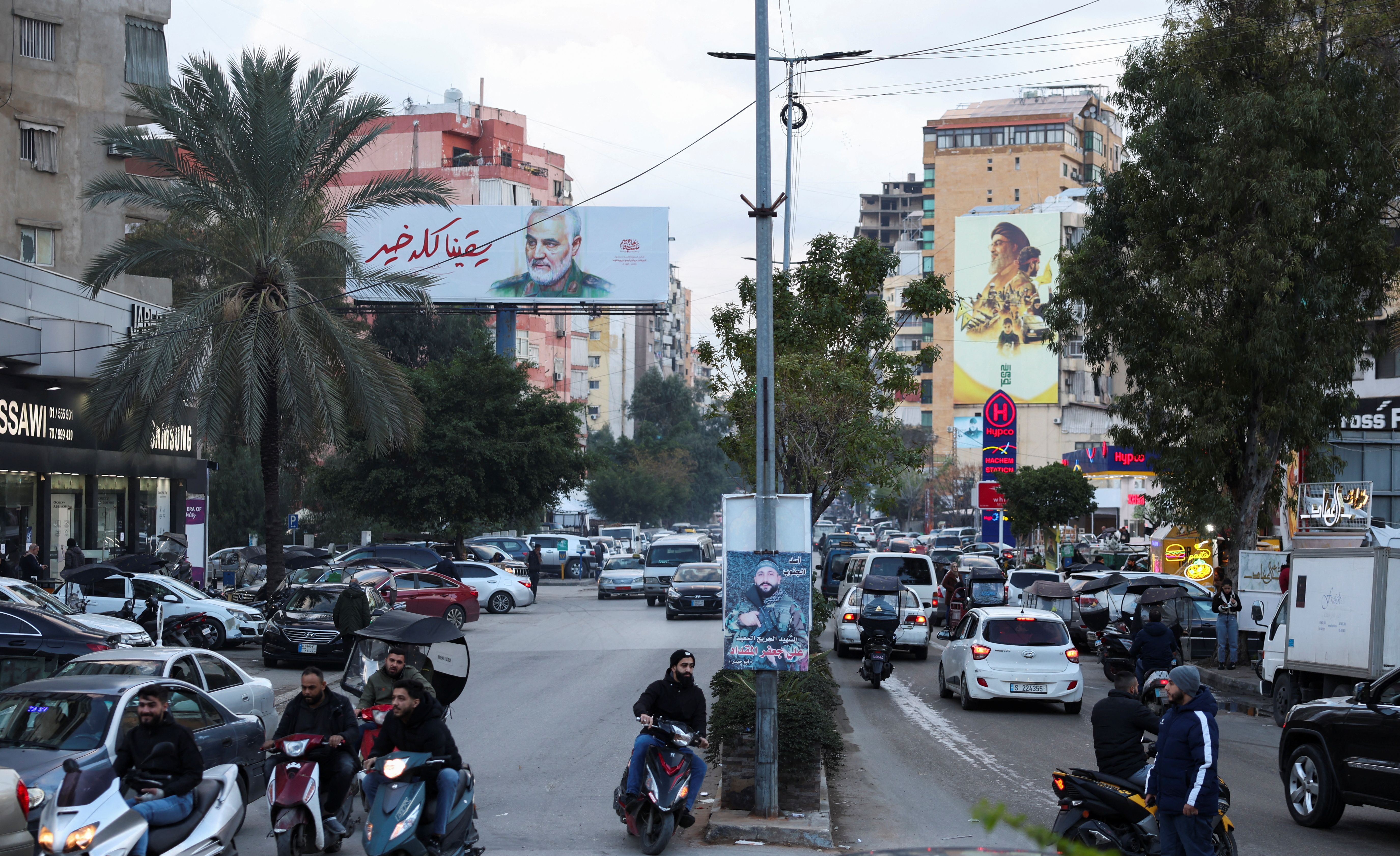 People ride on bikes in Beirut's southern suburbs, January 24, 2025. 