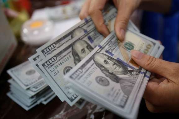 A currency dealer in Tehran handles dollars.