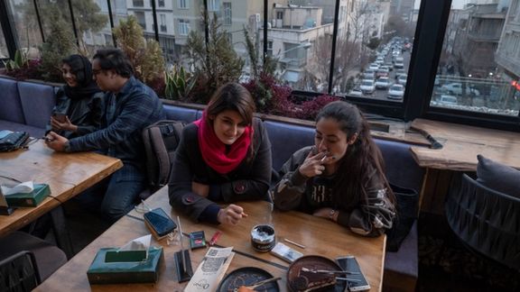 Iranian youths sit together at a cafe in downtown Tehran, January 29, 2023.
