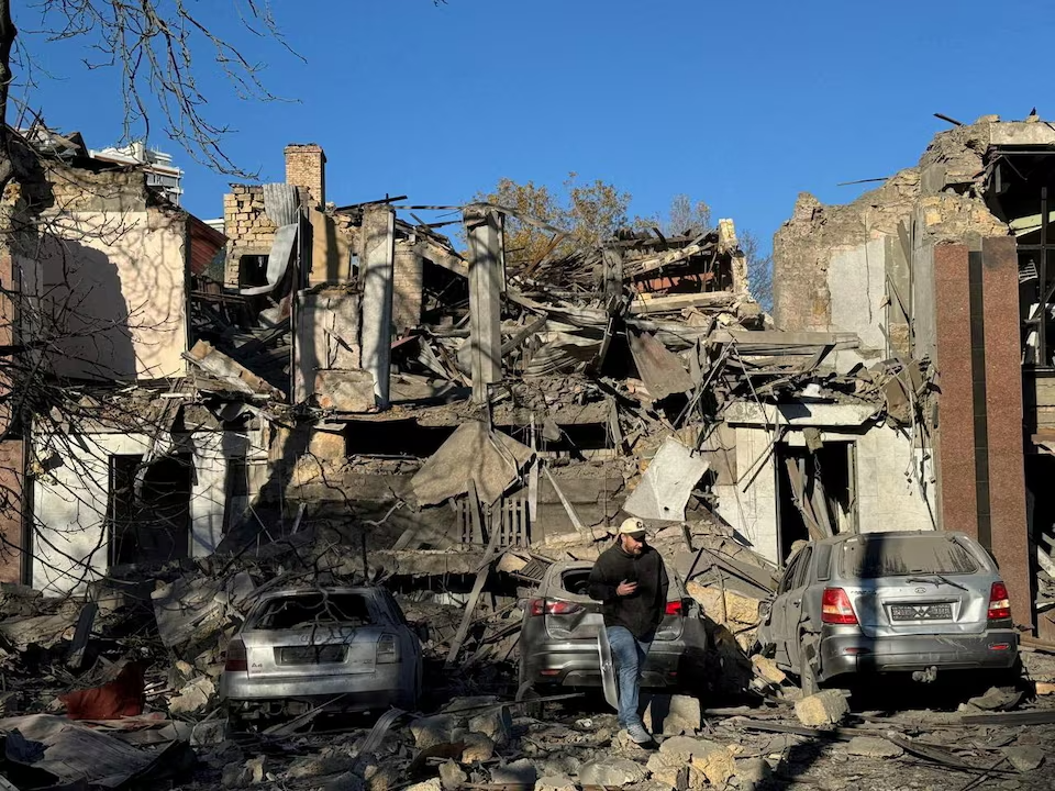 A resident walks next to buildings and cars heavily damaged by a Russian missile strike, amid Russia's attack on Ukraine, in Odesa, Ukraine November 25, 2024.