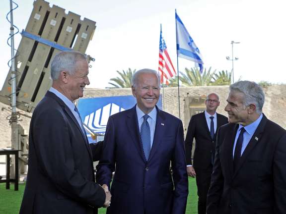 US President Joe Biden, Israeli caretaker Prime Minister Yair Lapid and Israeli Defense Minister Benny Gantz stand in front of Israel's Iron Dome defence system, during a tour at Ben Gurion Airport, July 13, 2022
