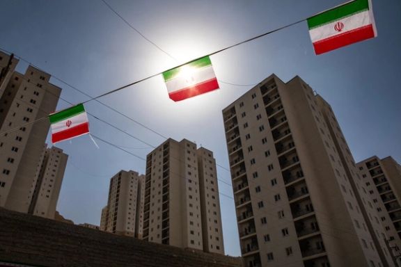 Small Iranian flags in a ceremony to mark the completion of a state housing project in northeast Tehran