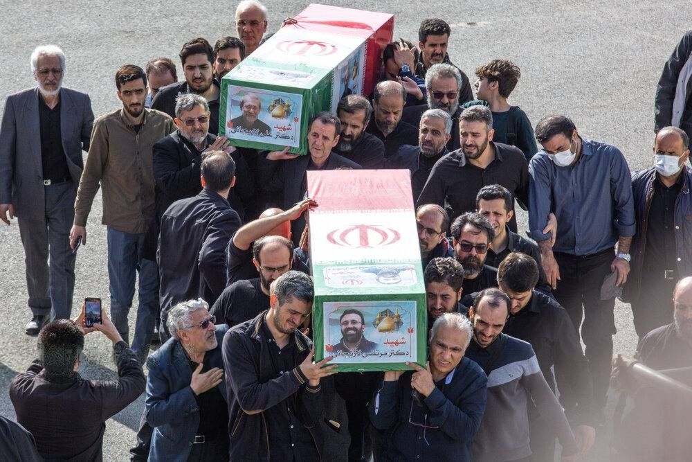 Mourners carry the coffins of Ali Larijani, former secretary of Iran’s Supreme National Security Council, and his son Morteza Larijani during their funeral procession in Qom, Iran, on March 19, 2026.