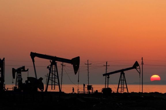 Pump jacks are silhouetted against the rising sun on an oilfield in Baku, Azerbaijan, January 24, 2013.