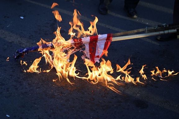 An American flag is torched by protesters in Tehran, Iran