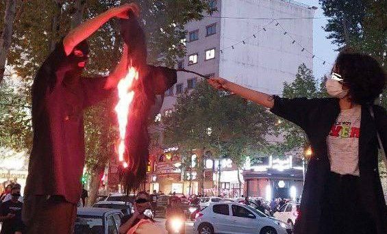 A woman burning her hijab headscarf in Lahijan, a provincial town, September 2022