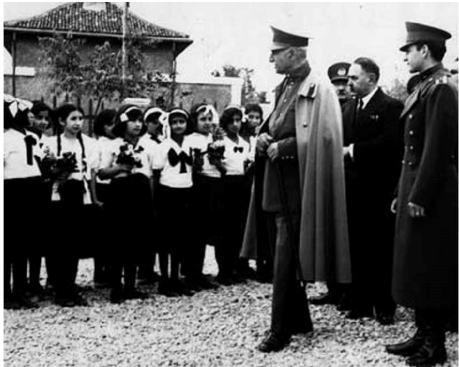 Reza Shah with unveiled schoolgirls (undated)