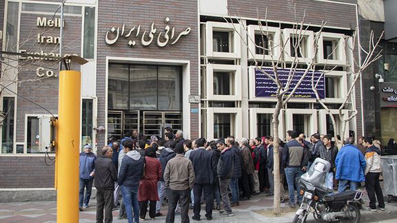 People in Tehran waiting to buy US dollars in a bank currency exchange office in March 2022
