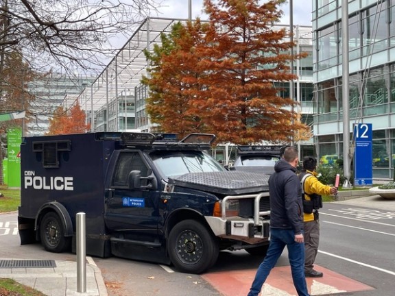 Armored police vehicles are seen outside the headquarters of Iran International