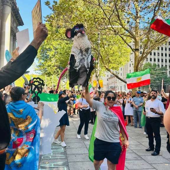 An Iranian protester holds an effigy depicting Supreme Leader Ali Khamenei with a rat’s head during a rally in Adelaide, Australia, in support of protests in Iran, January 2026.
