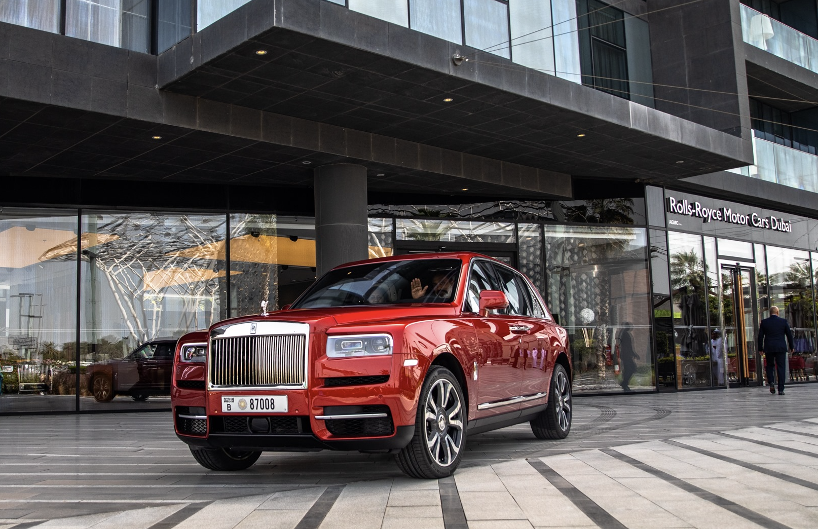 Jugwinder Singh Brar gestures as he drives a newly purchased Rolls-Royce Cullinan from a Dubai dealership, March 2020.