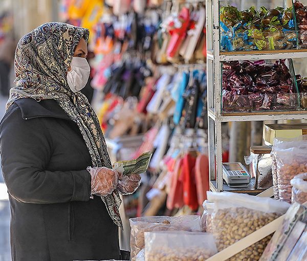 A woman shopping in Tehran with Iranian currency in hand (file photo)