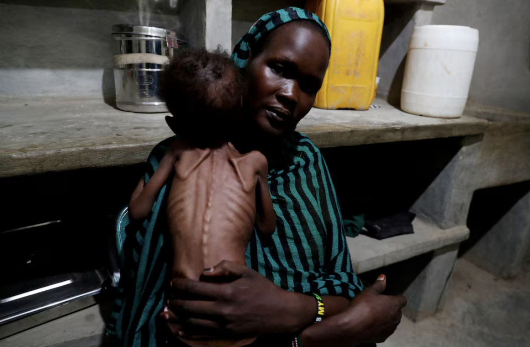 Robaika Peter, 25, holds her severely malnourished child at the paediatric ward of the Mother of Mercy Hospital in Gidel, South Kordofan, Sudan June 25, 2024. REUTERS