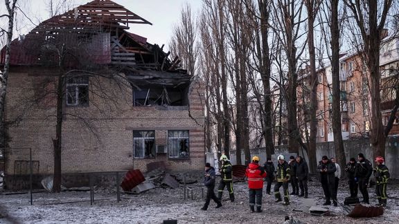 Rescuers and police officers examine parts of the drone at the site of a building destroyed by a Russian drone attack, as their attack on Ukraine continues, in Kyiv, December 14, 2022
