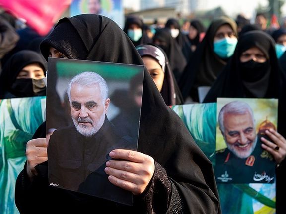Female protesters hold prints of slain IRGC Quds Force commander Qassem Soleimani in a state-sponsored rally in Tehran, Iran