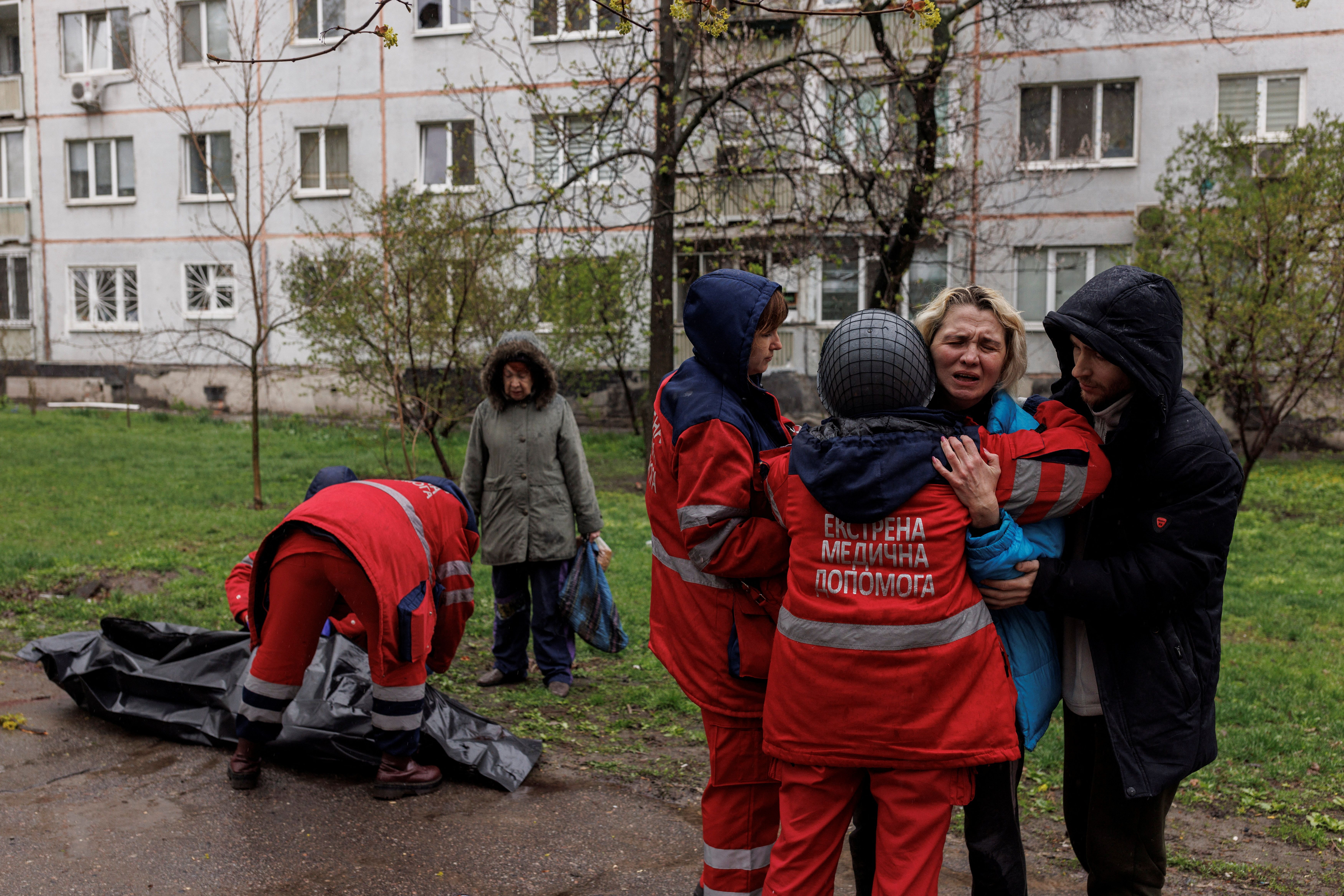 The body of an old man being retrieved after Russian shelling in Kharkiv. April 18, 2022