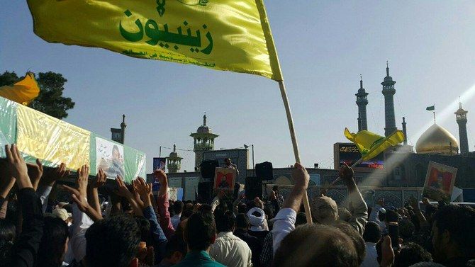 This photo shows a funeral procession of pro Iran militia members killed in Syria, and buried in Qom, Iran. The flag of Zainabiyoun Brigade, which is made up of Pakistani nationals, is in the foreground May 25, 2017.
