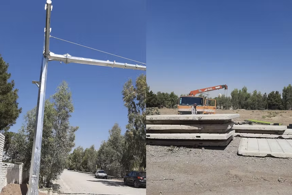 High concrete walls and surveillance cameras being installed at Khavaran