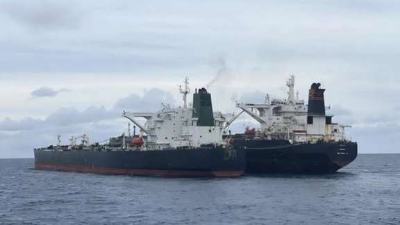 Two oil tankers transferring oil on seas, a common practice to hide origin of exporting country