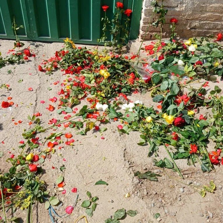 Flowers put outside the closed gate of Khavaran Cemetery (undated)