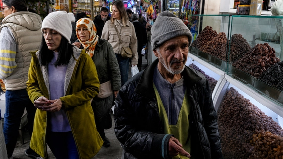 File photo of people walking through a traditional market in Iran.