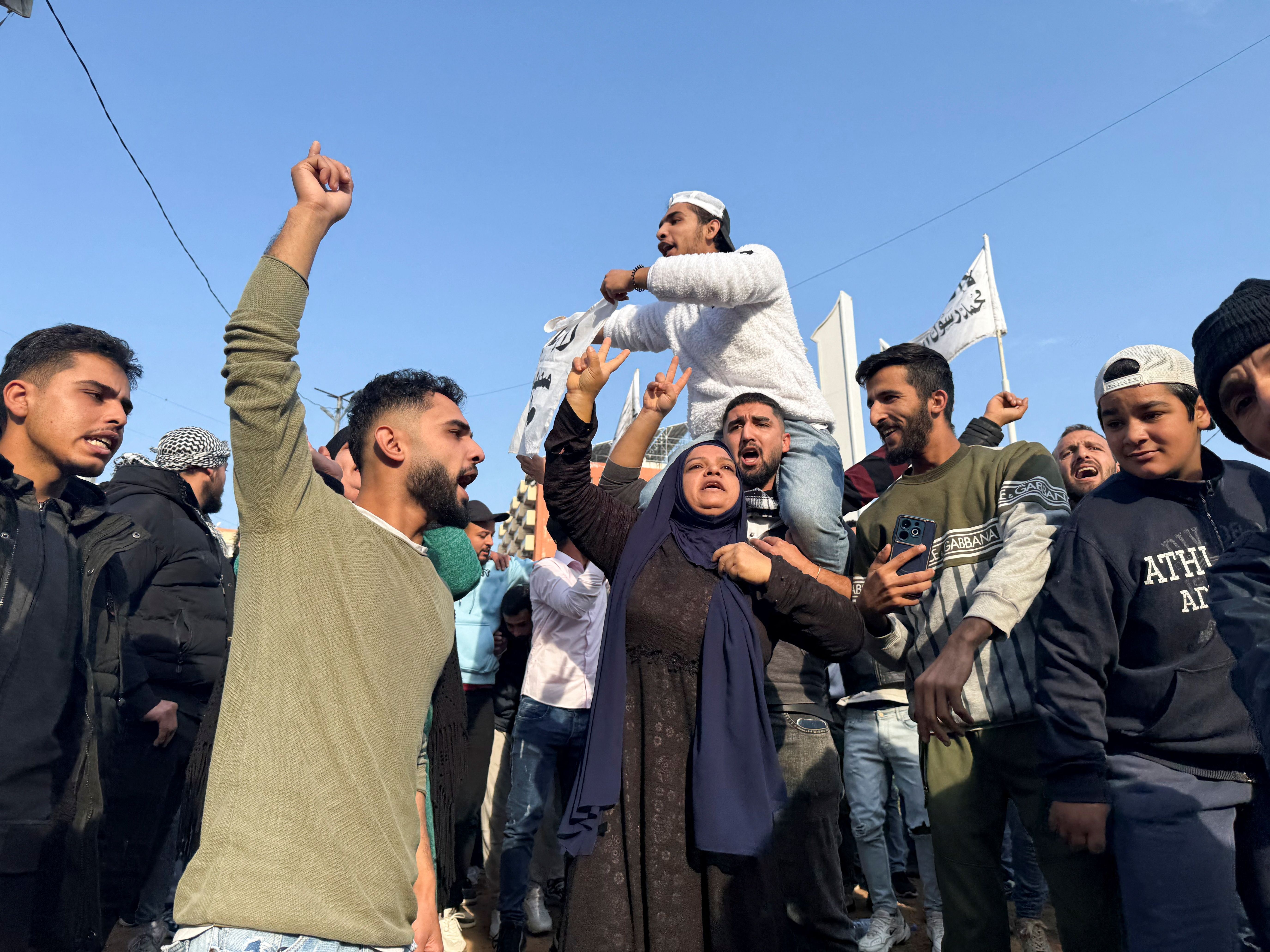 People gather as they celebrate, after Syrian rebels announced that they have ousted President Bashar al-Assad, in Tripoli, northern Lebanon December 8, 2024. 