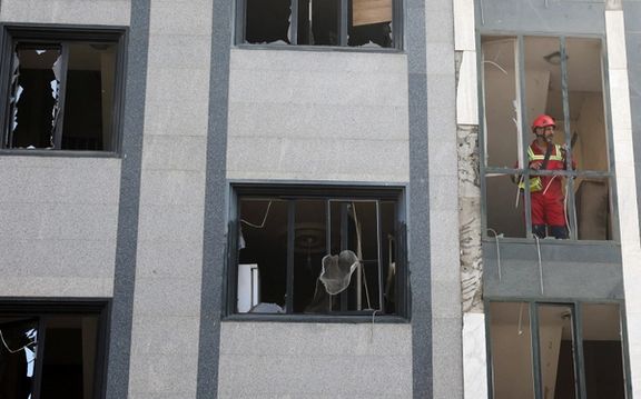 A rescuer looks out from a damaged building in the aftermath of Israeli strikes, in Tehran, Iran, June 13, 2025.