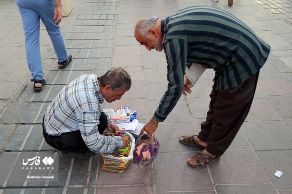An Iranian street vendor selling stationery in Tehran