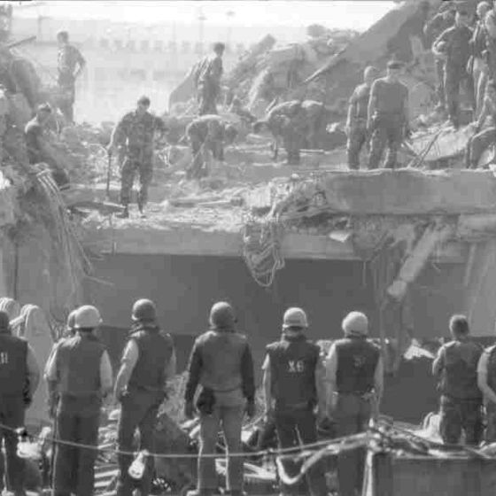 Rescue and clean-up crews search for casualties following the barracks bombing in Beirut on October 23, 1983.