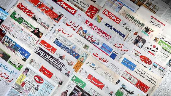 A number of newspapers at a kiosk in Tehran
