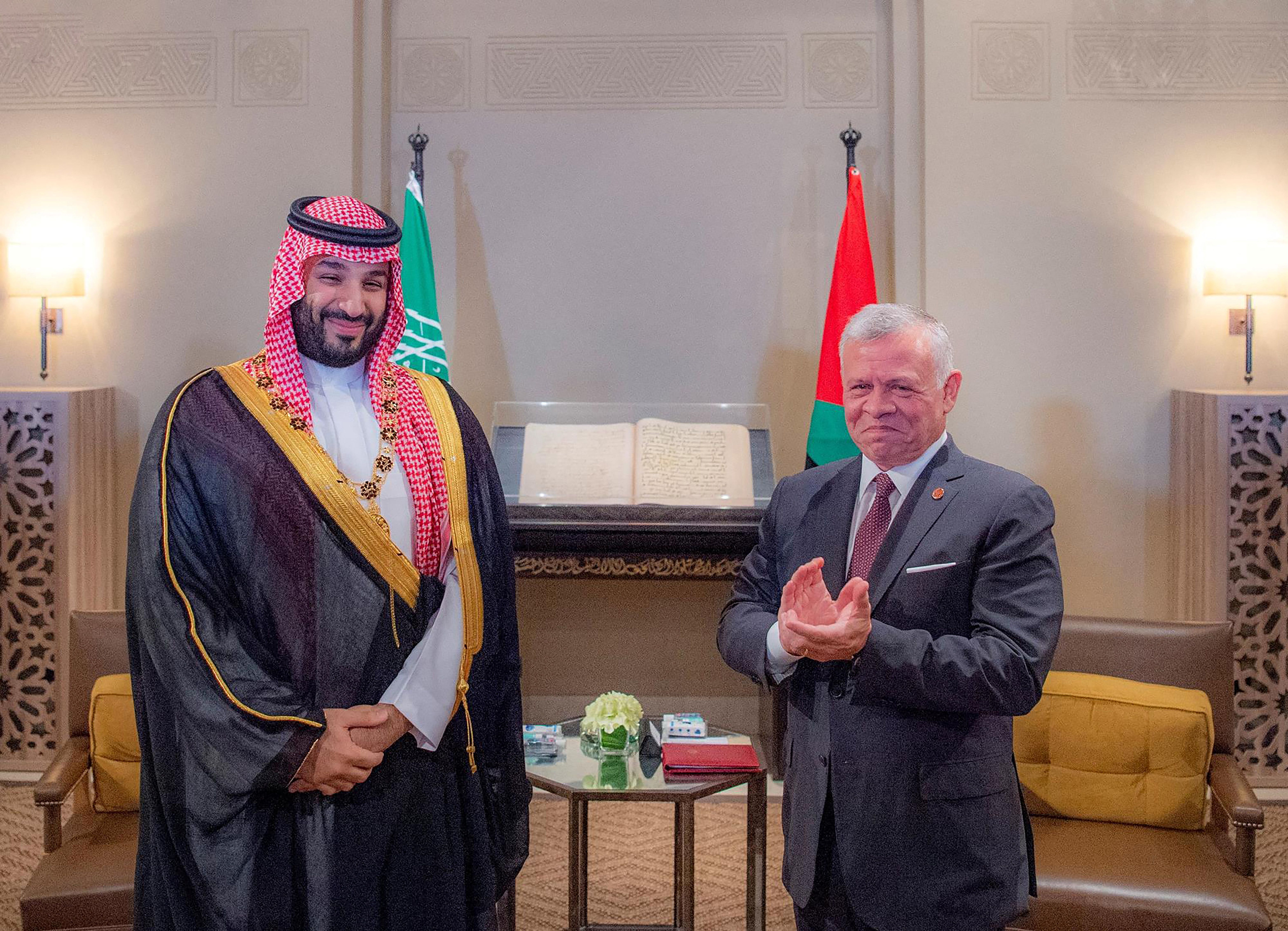 Jordan's King Abdullah ll presents a necklace to Saudi Crown Prince Mohammed bin Salman during his visit to Amman, Jordan, June 21, 2022.