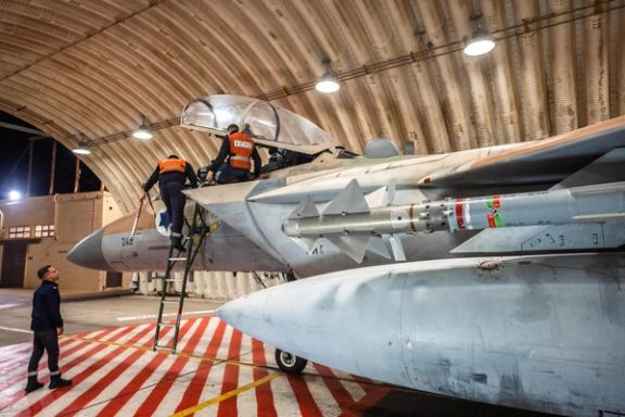 Crews work on an Israeli Air Force F-15 Eagle in a hangar, said to be following an interception mission of an Iranian drone and missile attack on Israel, in this handout image released April 14, 2024.