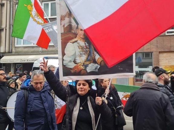 Protesters in Dusseldorf, Germany carrying a portrait of the late Shah Mohammad Reza Pahlavi on February 11, 2023