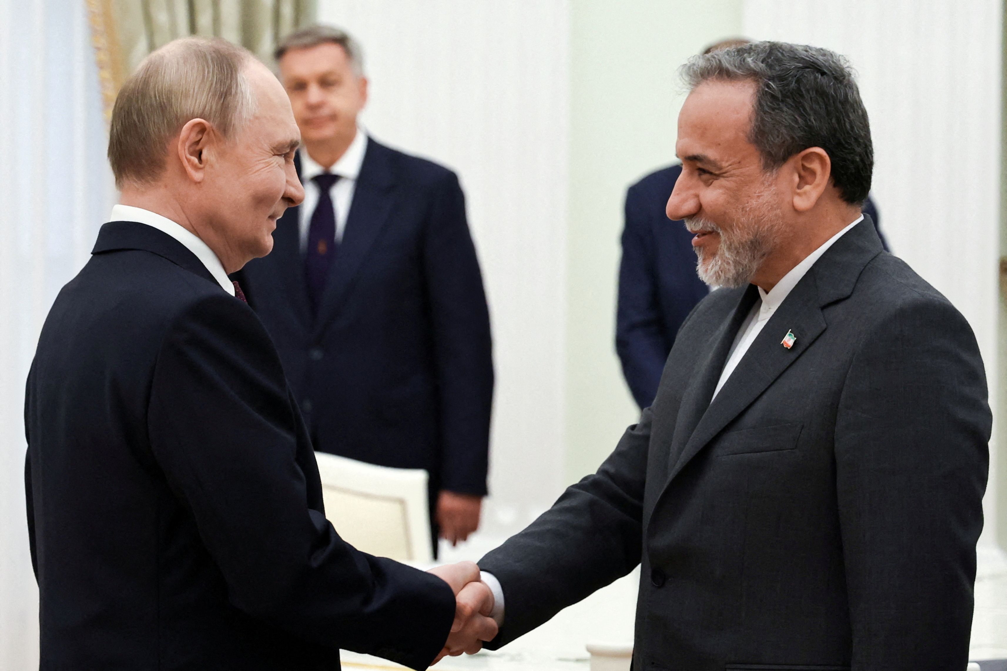 Russian President Vladimir Putin shakes hands with Iranian Foreign Minister Abbas Araqchi during a meeting at the Kremlin in Moscow, Russia June 23, 2025.
