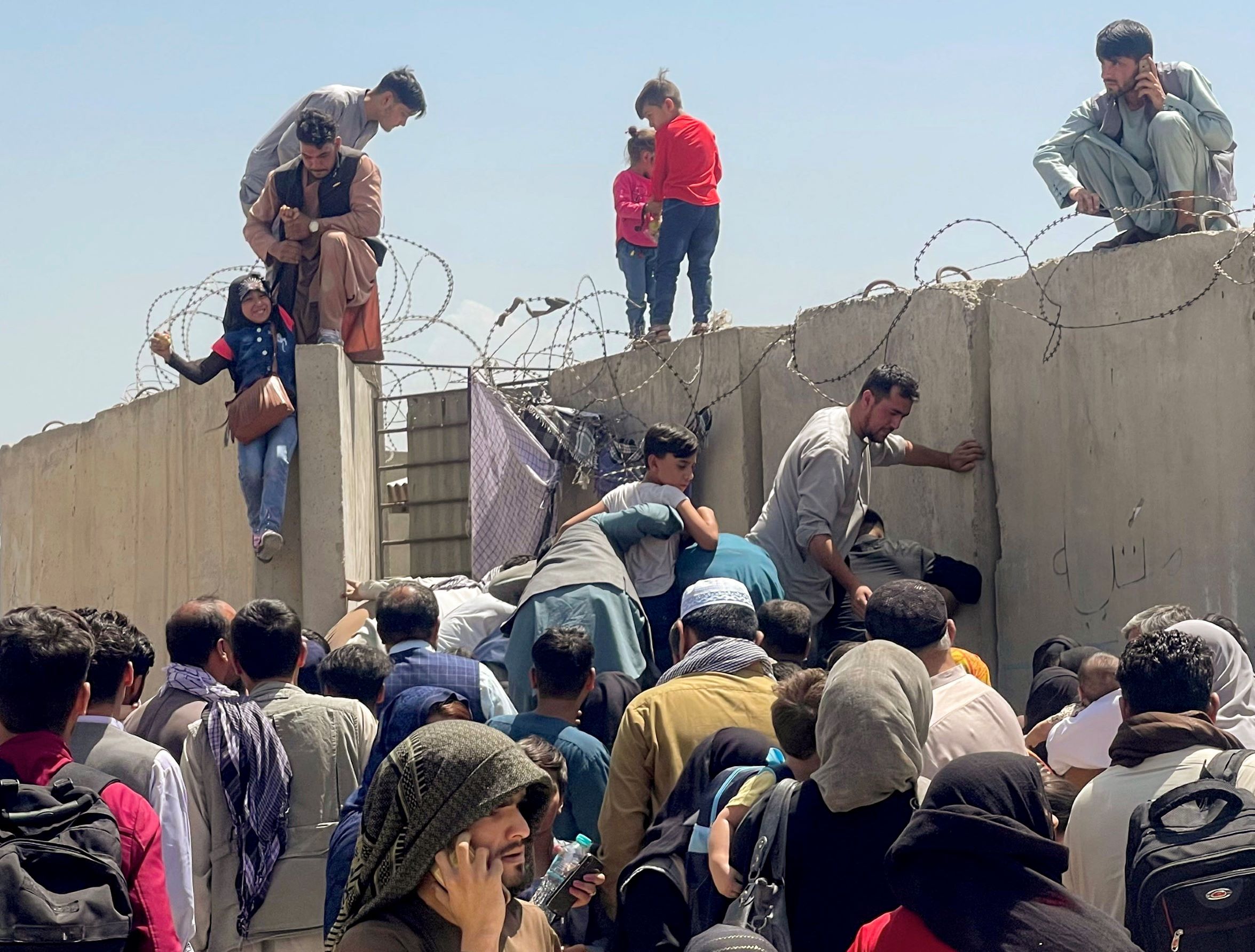Afghans trying to flee after the Taliban takeover, in Kabul airport. August 16, 2021