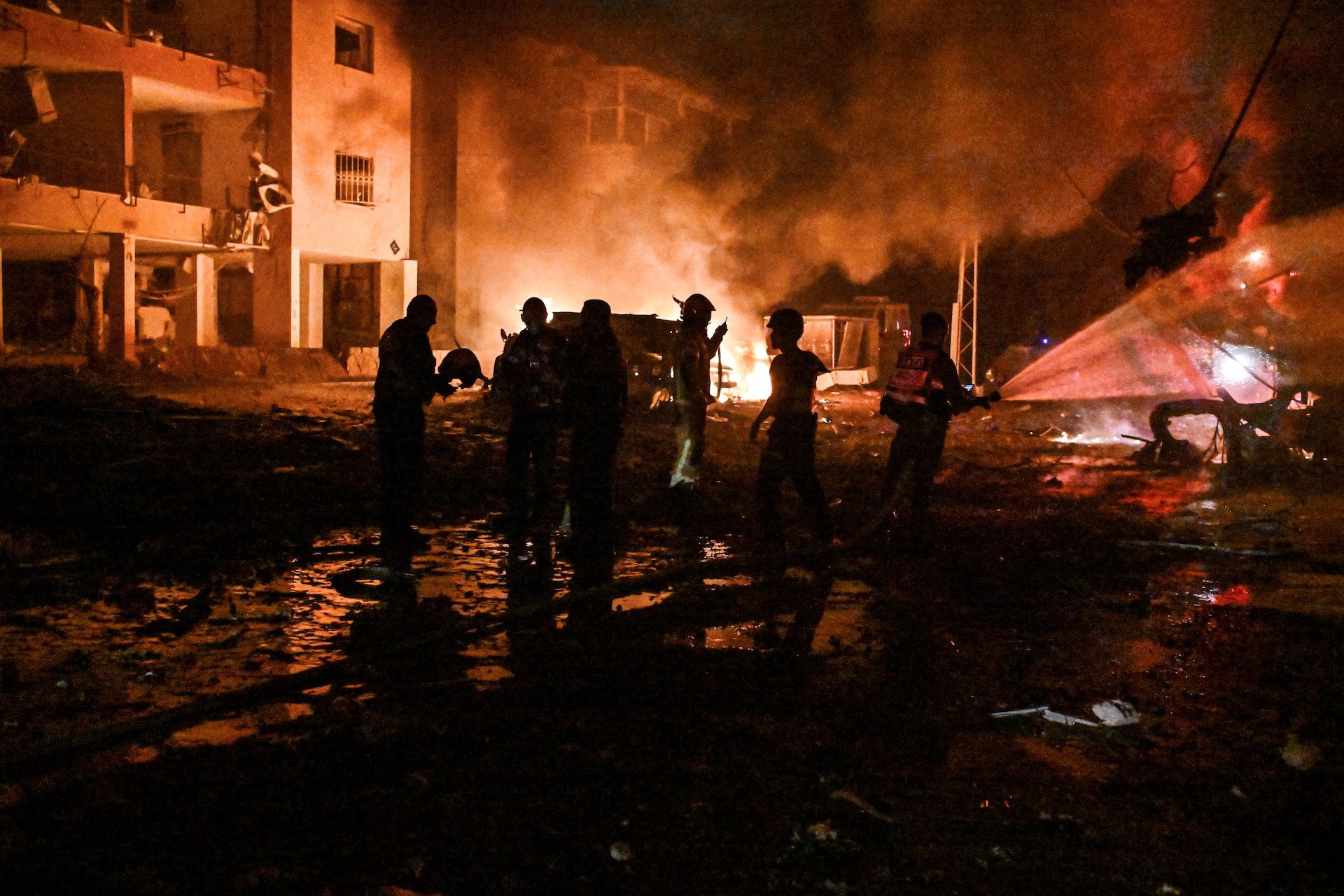 Firefighters and rescue personnel work at an impact site following missile attack from Iran on Israel, in Haifa, Israel, June 15 2025.