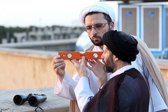 Two Iranian clerics trying to see the crescent moon at the end of Ramadan