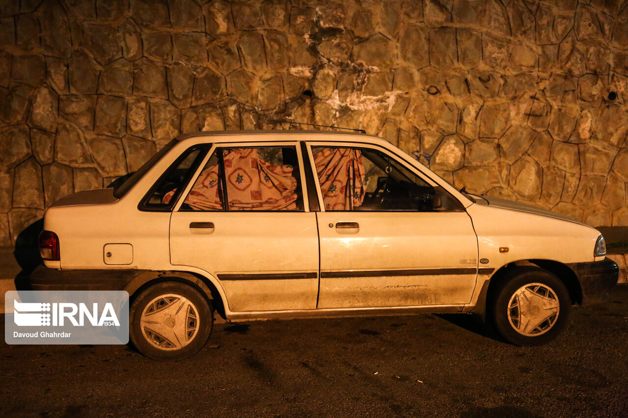 A photo of a car parked in northern Tehran, its driver asleep inside. (Undated)
