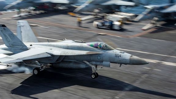 An F/A-18E Super Hornet fighter jet lands on the flight deck of the aircraft carrier USS Dwight D. Eisenhower. US Navy Photo posted on December 17, 2023