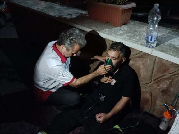 Emergency responders evacuate patients following a fire at Qaem Hospital in Rasht, northern Iran, on June 18, 2024