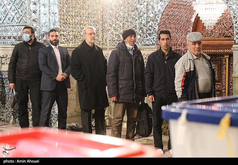 Iran’s former parliament Speaker Ali Larijani (3rd left) standing in line to vote in elections on March 1, 2024 