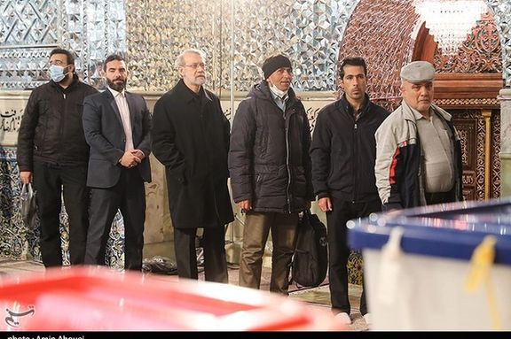 Iran’s former parliament Speaker Ali Larijani (3rd left) standing in line to vote in elections on March 1, 2024