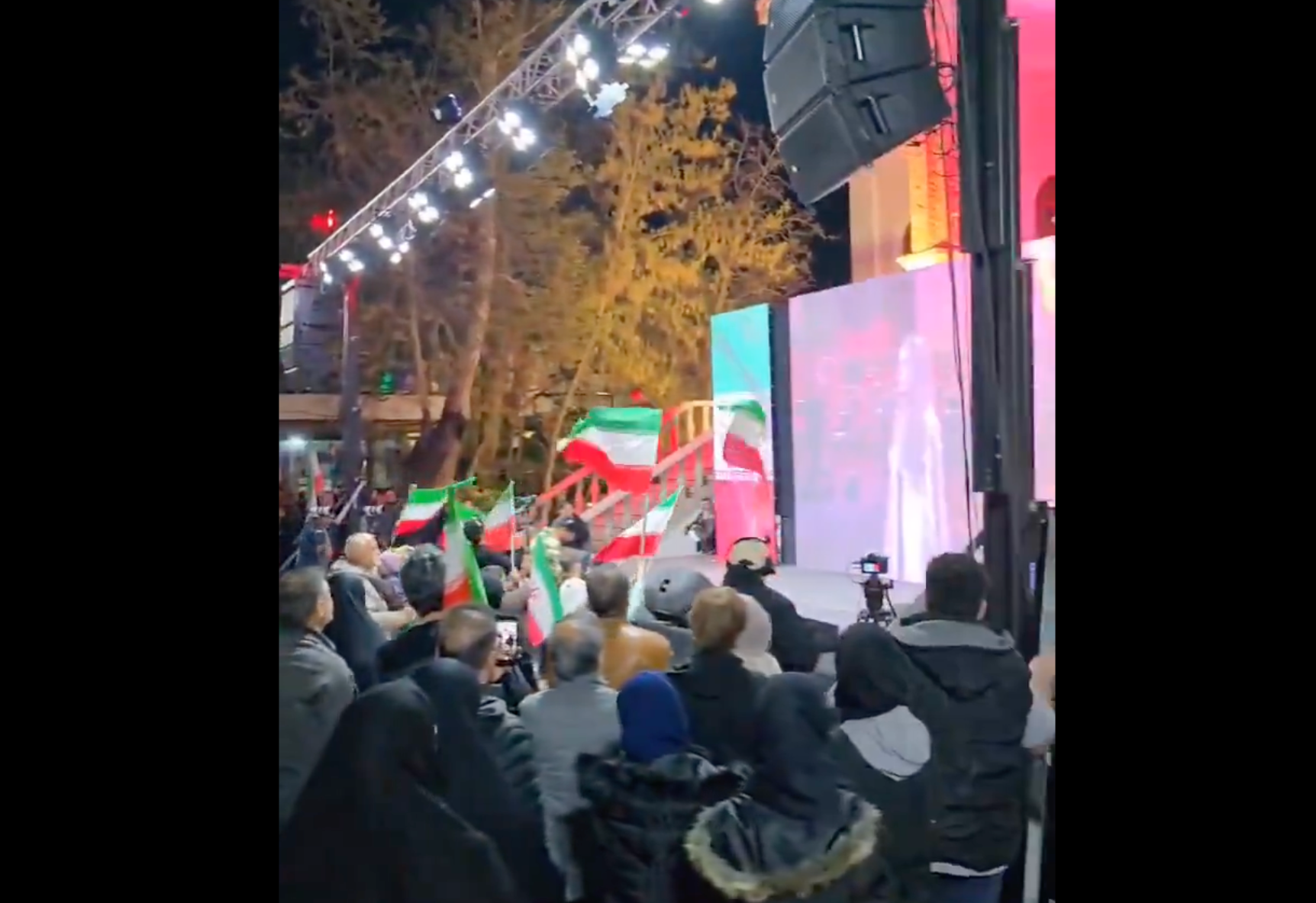 People at a state-sponsored rally in Tehran watch Lebanese singer Julia Boutros on a big screen, April 2026
