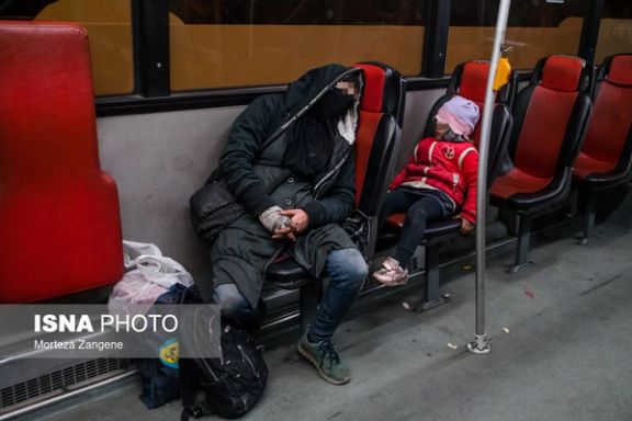 Homeless family sleeping on a night bus in Tehran, late December 2021.